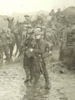  Photograph album, '1st Battalion, 1910-1914', compiled by Lieutenant Colonel H F Stoneham, 1909-1925: horse drawn transport passing through sodden country; a colums of horse drawn transport passing behind heavy artillery pieces [manned by Anzac troops?] (SHC ref ESR/25/STONHF/1 p34)