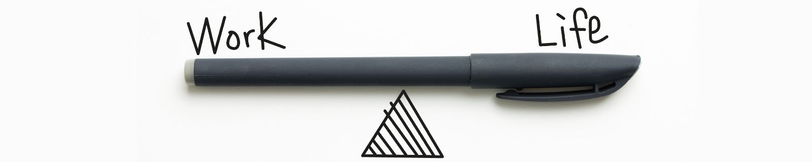A pen over a triangle acting like a see-saw with the words work and life on either side