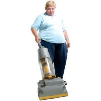Woman using a large upright vacuum cleaner.