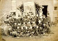 In common with other schools and similar institutions at the time, Byfleet Industrial School had its resident band. The band members, posed with their instruments, are in front of the school buildings, facing onto Parvis Road