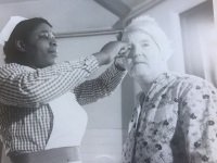 Black nurse treating a patient at Netherne Hospital c1955