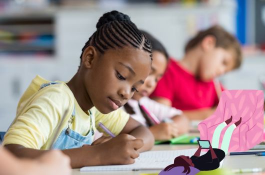 Children sitting at tables writing and drawing