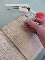 Cleaning the pages of the clergyman's notebook