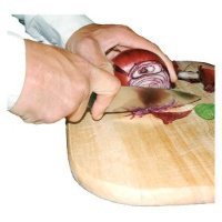 Close-up of hands chopping a red onion on a wooden board.