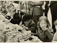 Photo of children enjoying party food at Ford Road street party 1953