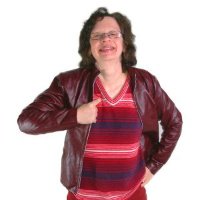 Woman in a red striped jumper with a leather jacket, smiling confidently.