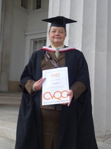 Susanne, wearing her robes after achieving her CVQO qualification