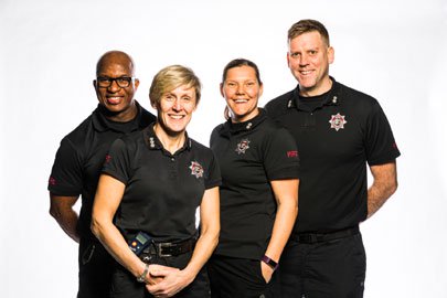 Group of four fire fighters in black uniform.