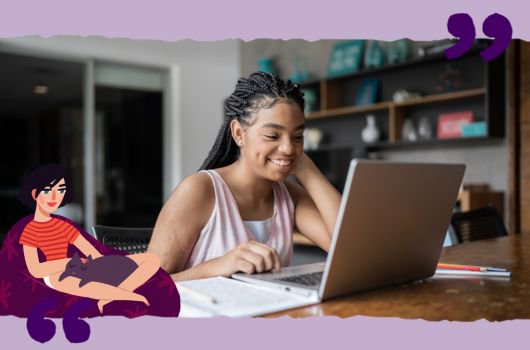 A young woman sitting at a table with a laptop.