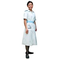 Nurse in a white uniform standing and smiling.