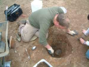 Digging a pit during excavations at St. Ann's Heath Primary School