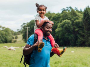 Dad and child enjoying a walk in the countryside.