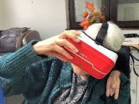 Older person wearing a virtual reality headset
