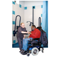 Support worker assisting a man in a wheelchair in a bathroom with grab rails and accessible shower.