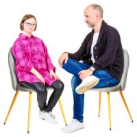 Two people talking on chairs