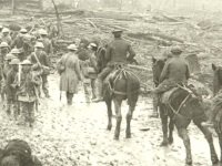  column of troops passing through an undamaged [French or Belgian] village past 2 steam engines or tractors; a column of troops standing easy in wet boggy country near the Front (SHC ref ESR/25/STONHF/1 p33)