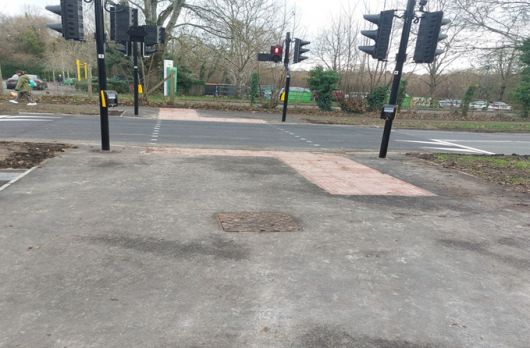 A set of traffic lights with blister paving