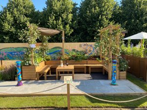 View of show garden with light wood benches