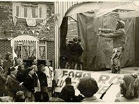 Photo of Mr Hayward playing the spoons on stage at Ford Road street party 1953