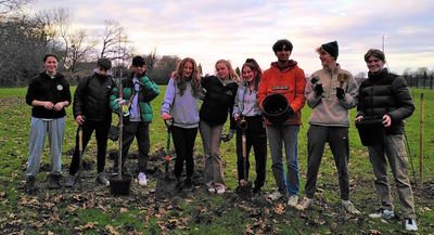 A group of school children from George Abbott school who have taken part in a tree planting exercise with Surrey County Council