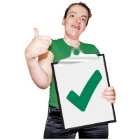 Young person holding up a clipboard with green tick