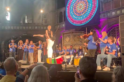 Music Connects' participants perform music, dancing and singing on stage to a seated audience in Union Chappell, London