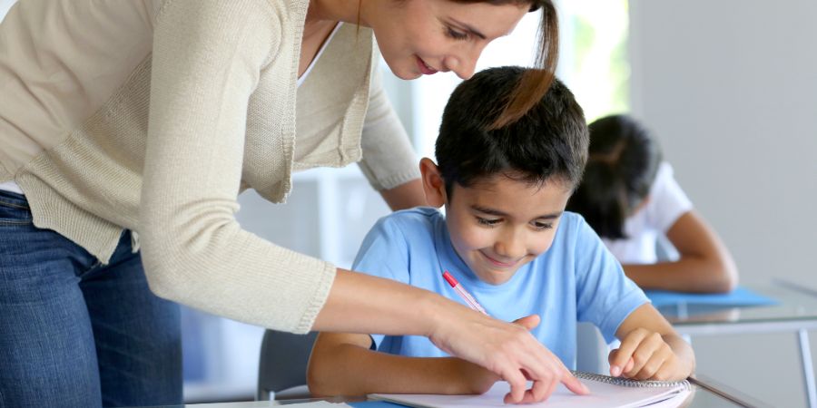 Teacher helps child with work