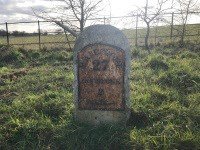 Milestone with a cast iron plate on A25 Oxted Road 