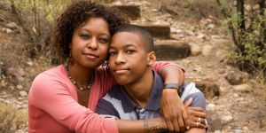 Mother and son hug each other while out on a walk