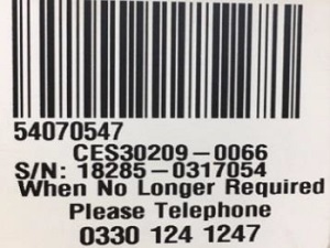 Image of sticker that shows a bar code and unique numbers for the CES to identify the equipment. It also shows a number to call to arrange return of the equipment.