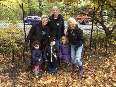 Volunteers and children from Disability Challengers planting trees in the community